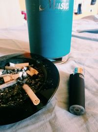 High angle view of cigarette smoking on table