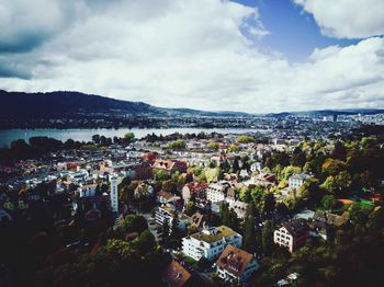 High angle view of town by sea against sky