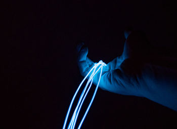 Close-up of hands against blue background