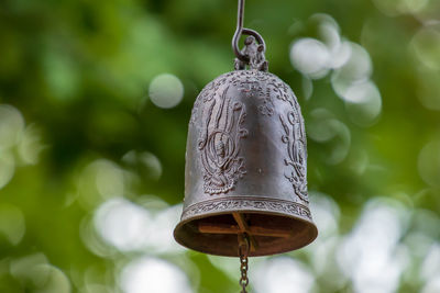 Close-up of bell hanging on metal