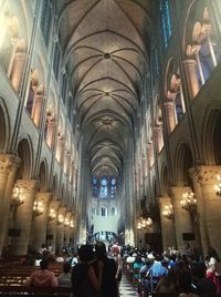 People in illuminated cathedral