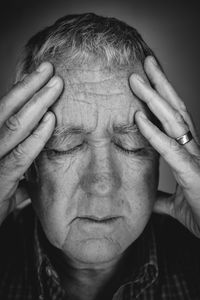 Close-up of man suffering from headache