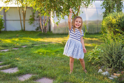 Portrait of smiling girl standing on field