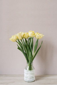 Bouquet of yellow tulips in a vase. spring flowers. bouquet in a vase. cozy still life. copy space.