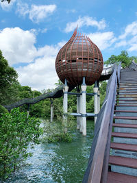 View of bridge over river against cloudy sky