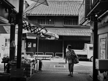 Rear view of woman walking in city