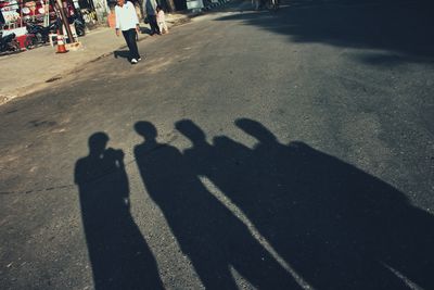 Shadow of people on street in city