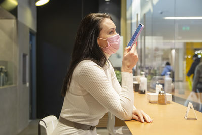 Portrait of young woman using mobile phone