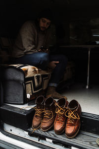 Side view of calm male traveler sitting in parked van and resting on cloudy day