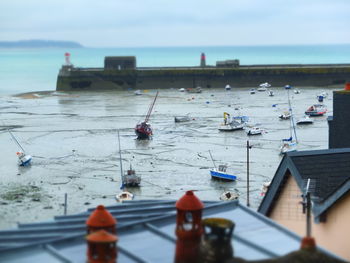 Close-up of boats in sea against sky