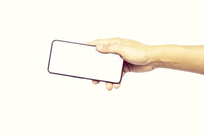 Midsection of person holding mobile phone over white background