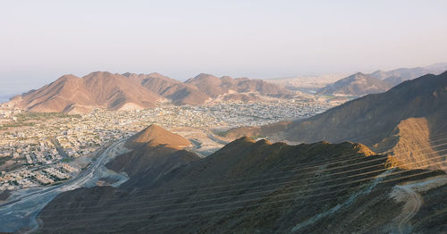 Scenic view of desert mountains against clear sky in khorfakan uae. 