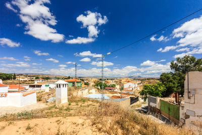 Houses in town against sky