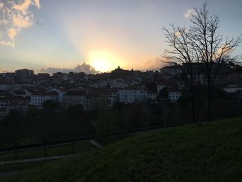 Buildings in city at sunset