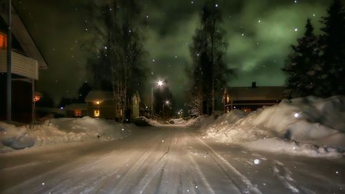 Snow covered road at night