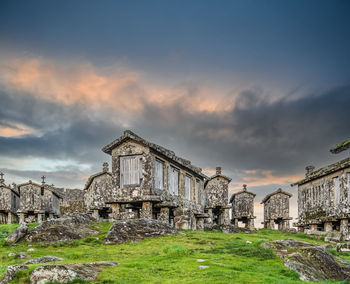 Old building on field against sky