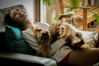 Happy woman with dog at home
