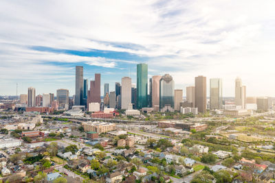 Aerial view of modern buildings in city against sky