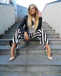 Low angle portrait of young women sitting on steps