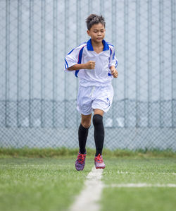 Boy football player training session running exercise for children