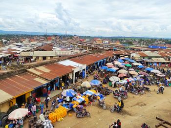 High angle view of people at market against sky