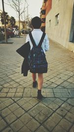 Woman standing on footpath