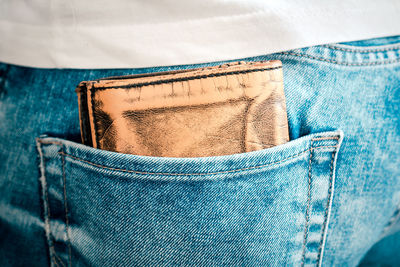 Close-up of wallet in jeans pocket