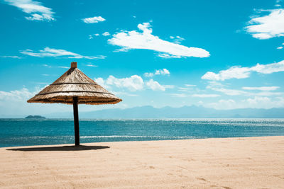 Lifeguard hut on beach against sky