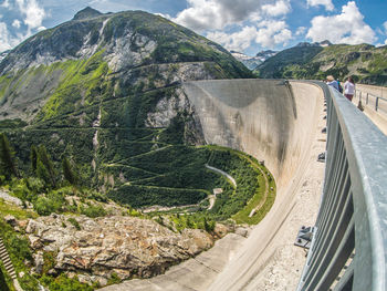 Road amidst green mountains against sky