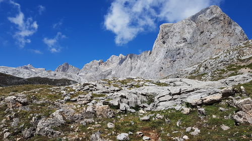 Low angle view of rocks on mountain against sky