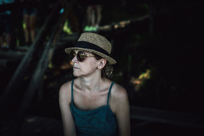 Mature woman wearing hat and sunglasses