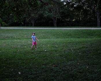 Full length of boy playing on grassy field