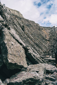 Low angle view of rock formation against sky