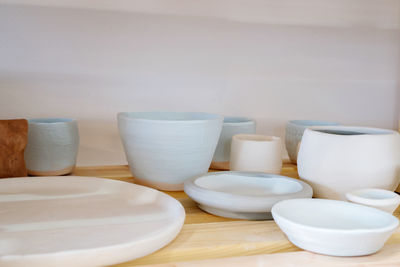 Pottery plates and bowls drying out waiting to be glazed