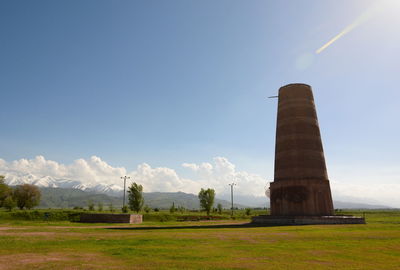 Built structure on field against sky