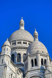 Low angle view of church against blue sky