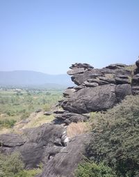 Rock formations on landscape against clear sky