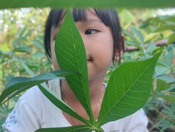 Close-up portrait of girl with leaves