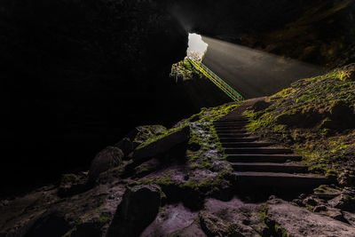 Staircase leading towards mountain at night