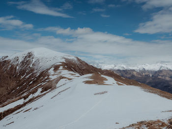 Scenic view of snowcapped mountains against sky