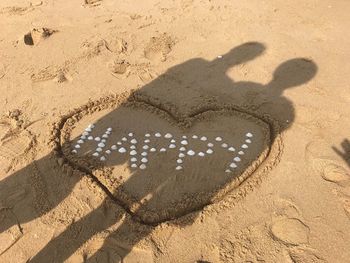 High angle view of footprints on sand at beach