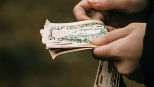 Close-up of man holding paper currency