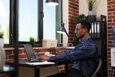 Businessman using laptop at office