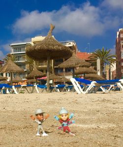 Group of people on beach against buildings