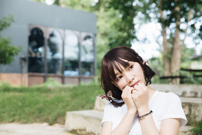 Portrait of a young woman sitting outdoors