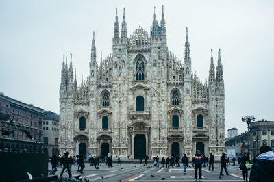 People at milan cathedral against sky