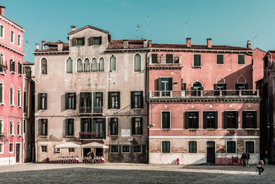 Buildings in city against clear sky