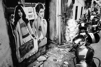 Portrait of woman standing against abandoned wall