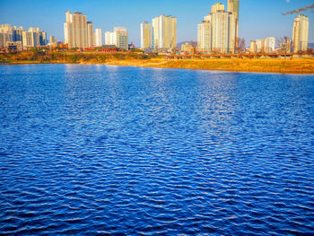 View of city by sea against sky