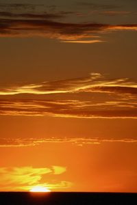 Scenic view of dramatic sky over sea during sunset